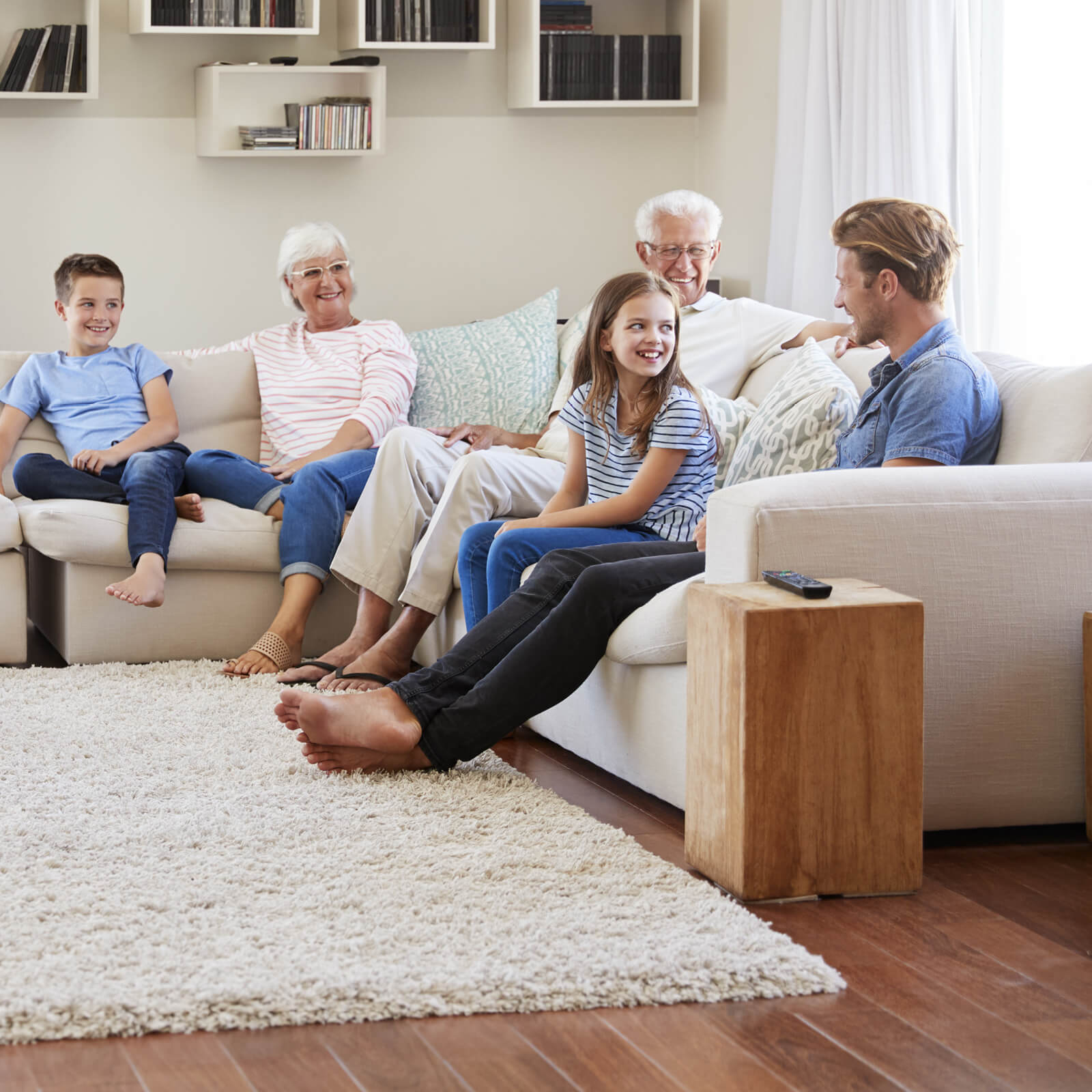 Family having good time sitting in living room | Rich's Modern Flooring